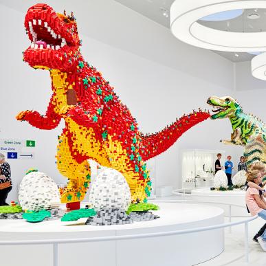 See the fascinating giant dinosaurs in the LEGO® House Masterpiece Gallery. Many people are doing exactly what this family is doing: taking a selfie or a photo with a wild dinosaur in the background.